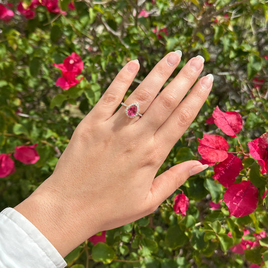 Pear shaped Pink Tourmaline Ring with natural diamonds worn on a hand