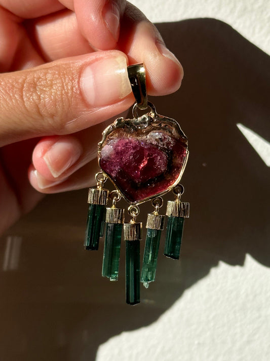 watermelon tourmaline pendant being held by hand
