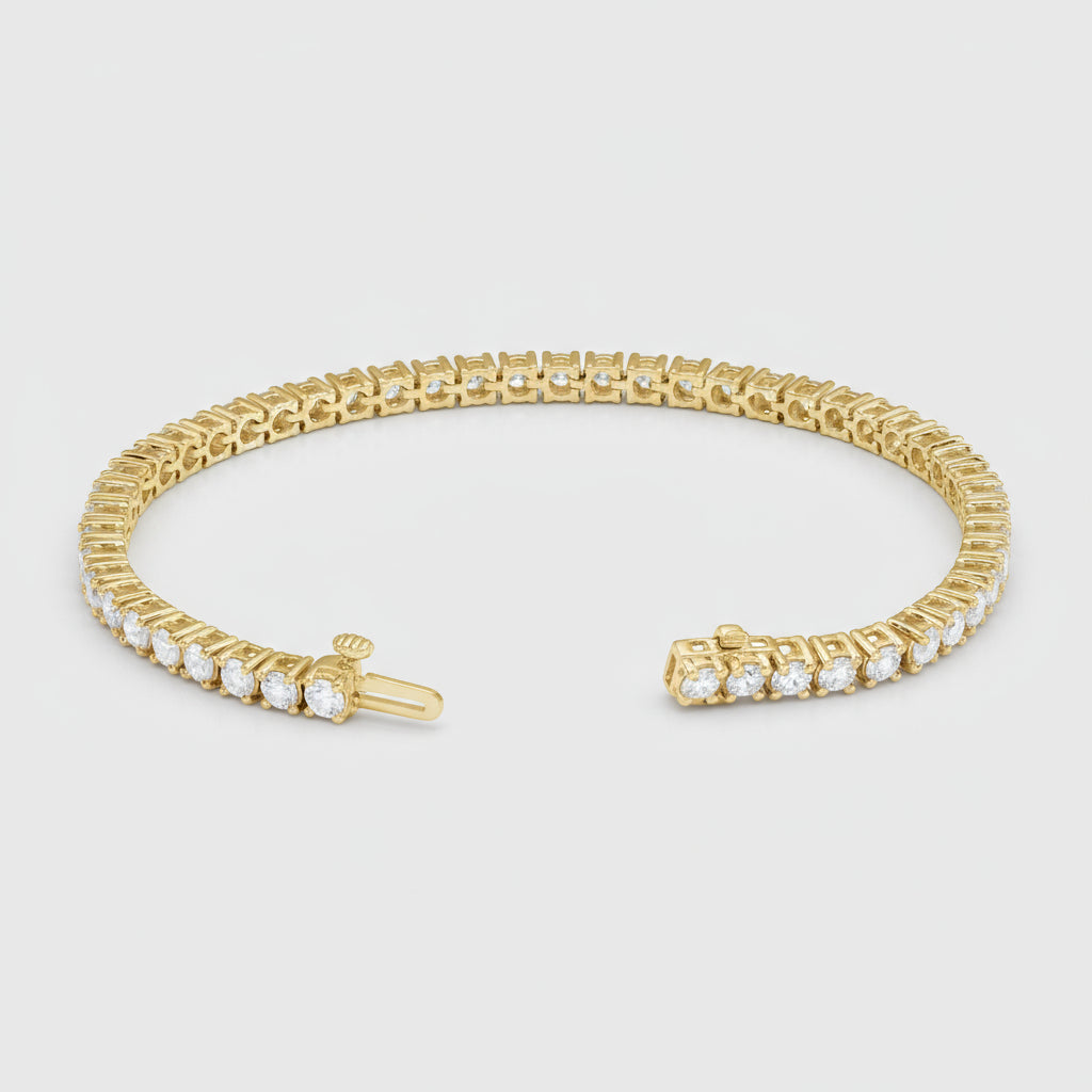 Gold diamond tennis bracelet on a white background