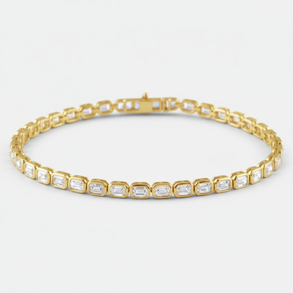 Gold bracelet with emerald-cut diamonds on a white background
