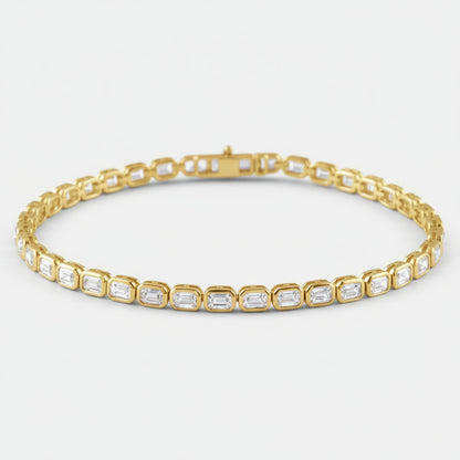 Gold bracelet with emerald-cut diamonds on a white background