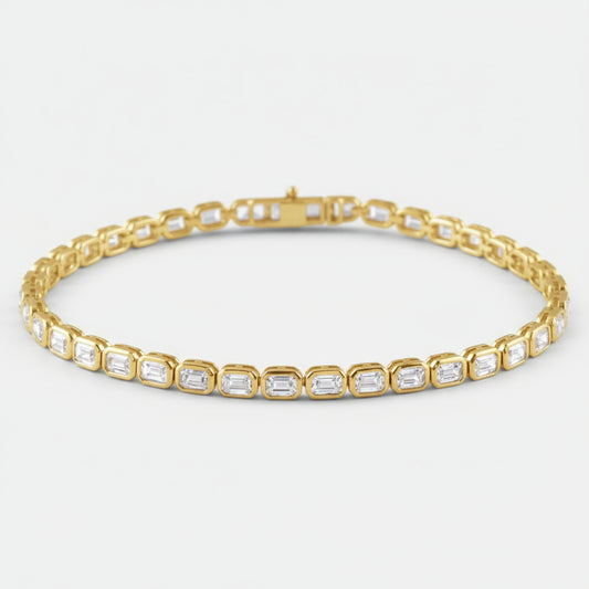 Gold bracelet with emerald-cut diamonds on a white background