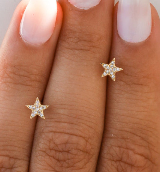 Star-shaped earrings on a hand