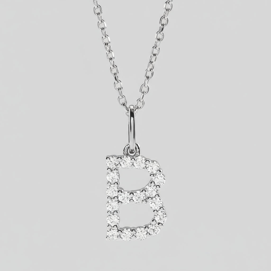 Silver necklace with a letter 'B' pendant on a light gray background