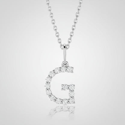 Silver necklace with a letter 'G' pendant on a beige background