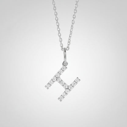 Silver necklace with a diamond-studded 'H' pendant on a light gray background