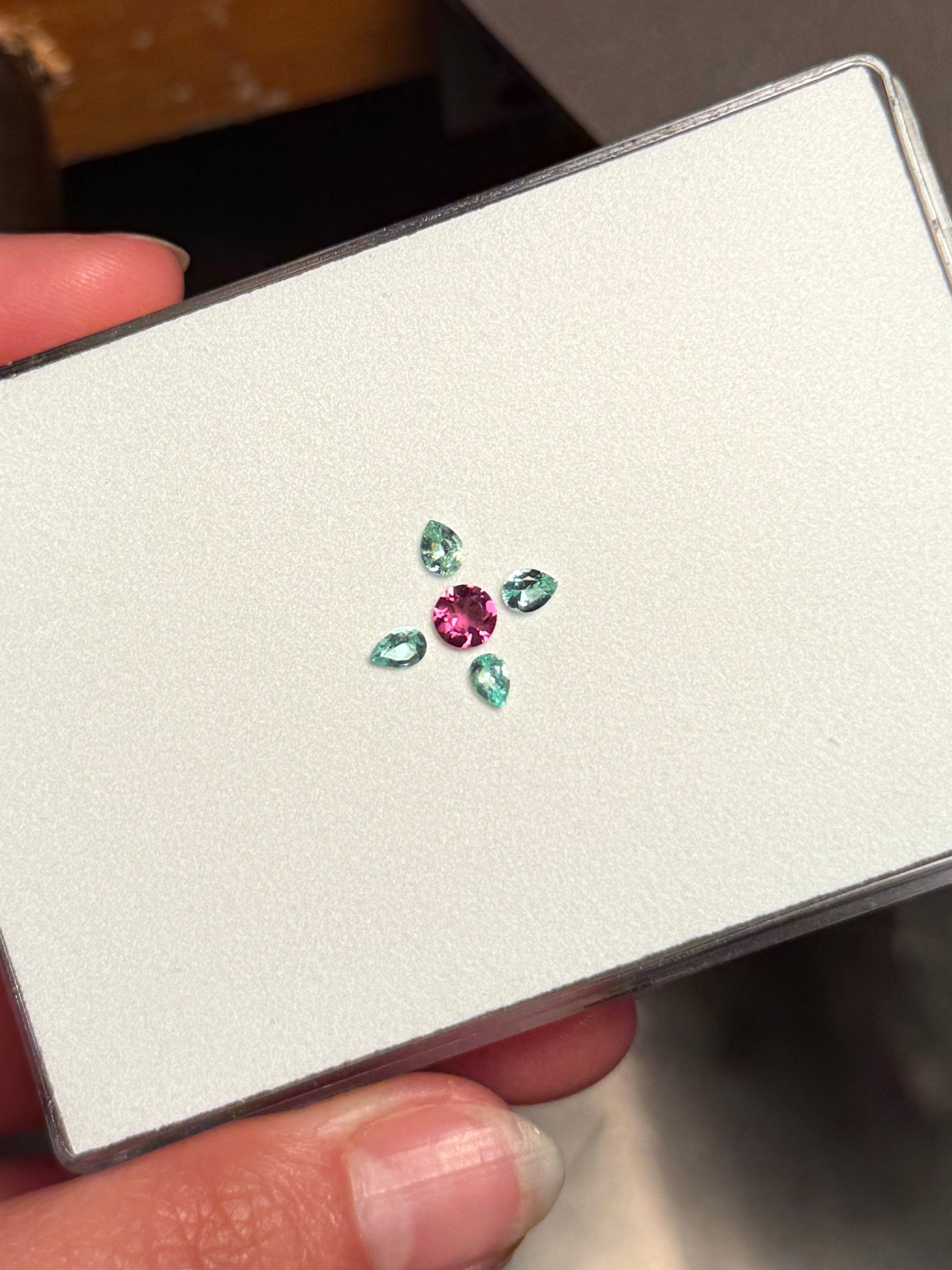 A beautiful compass layout with 4 paraiba tourmaline and a purplish pink cuprian tourmaline.