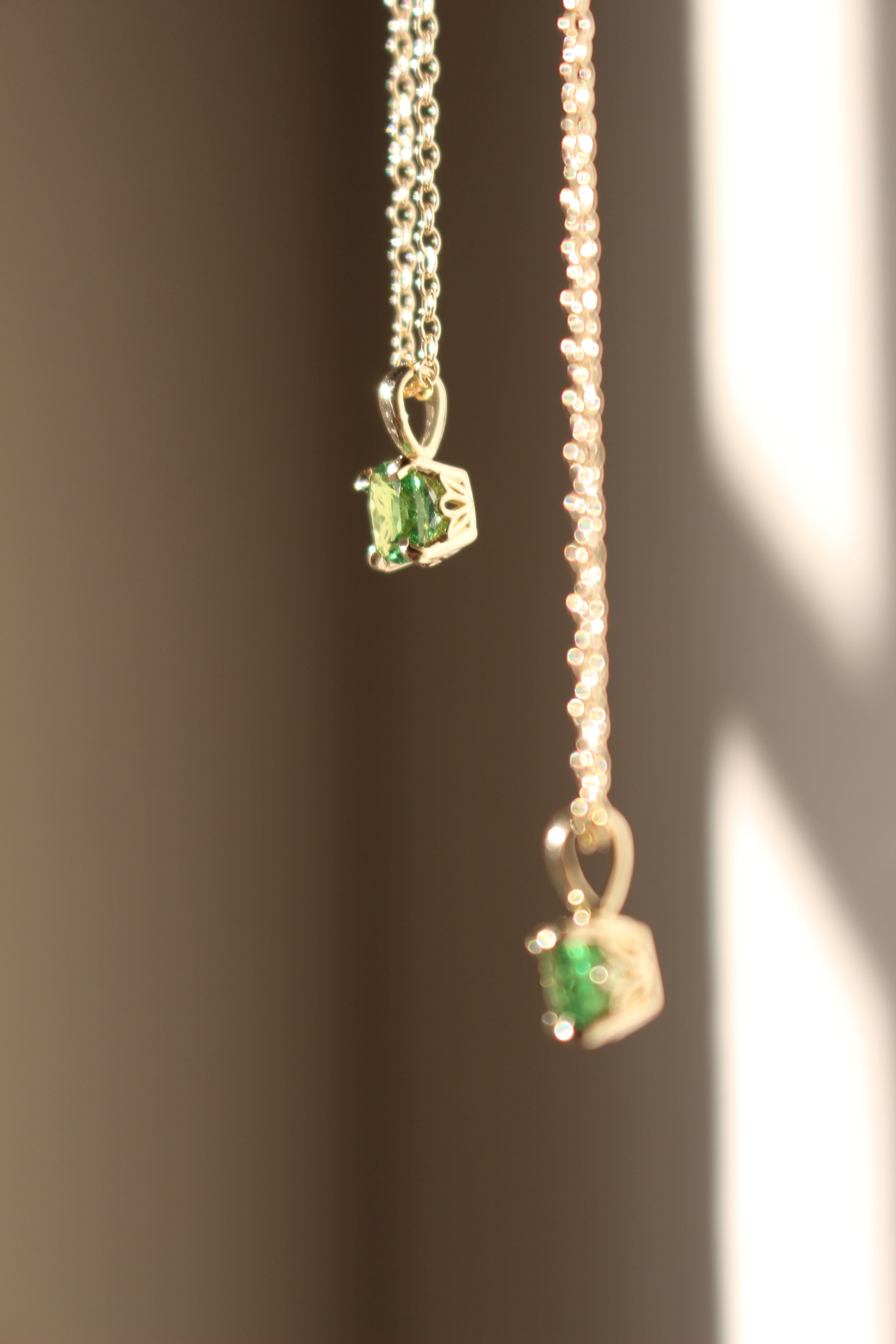 Side Profile view of Tsavorite Garnet necklaces
