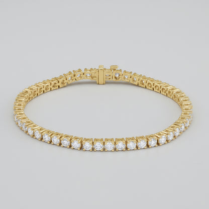 Gold bracelet with clear gemstones on a white background