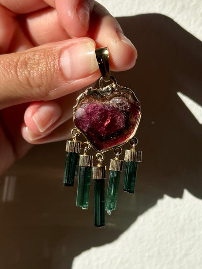 watermelon tourmaline pendant being held by hand